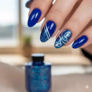 Creative nail art design using blue sparkle nail polish as an accent layer over a plain blue base.