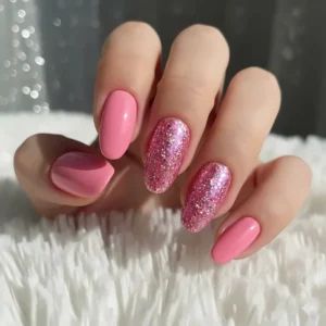 Glamorous nail art design using glitter pink gel nail polish on an accent nail for a sparkle effect.