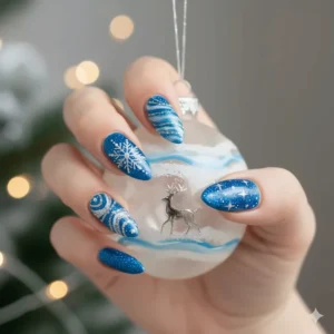 Festive nail art design using blue glitter nail polish perfect for the winter holidays.