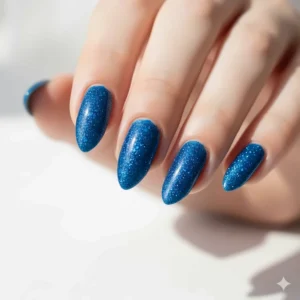 Fingernails showing full coverage and sparkle after two coats of blue glitter polish.