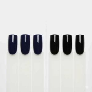 Swatch comparison showing the subtle difference between navy blue nail polish and a standard black polish on nail tips.