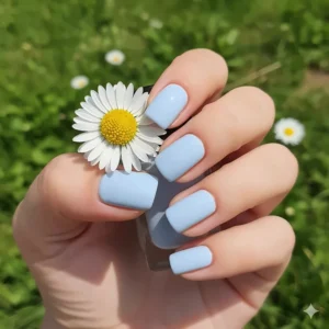 Elegant, pale pastel baby blue nail polish applied neatly to short, squared nails, ideal for spring.