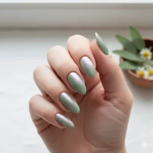 Trendy glazed chrome finish over sage green nail polish, creating a shimmery, 'glazed donut' effect.