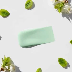 Swatch of a popular pastel light green nail polish shade on a white background, perfect for spring.