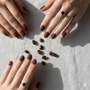 Flat lay of hands featuring a velvet matte dark brown nail polish finish.