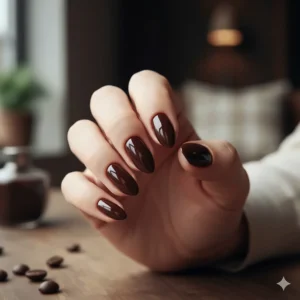 Close-up of deep espresso brown nail polish with a high-shine finish.