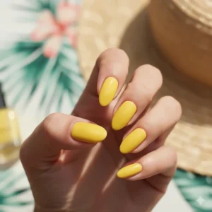 A hand swatch showing the opaque, bright yellow nail polish shade on medium skin tone, ideal for summer.