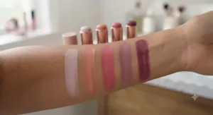 Various popular stick blush shades swatched on a medium skin tone forearm