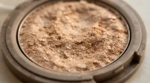 Macro view of silky smooth bronzer for pale skin that avoids orange tones in the pan