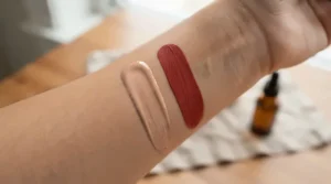 Comparison of cream bronzer vs powder bronzer for dry skin showing smooth textures on a model's arm.
