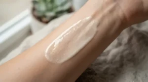 A detailed texture swatch of an illuminating primer for dry skin showing light-reflecting micro-pearls