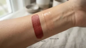 liquid highlighter vs powder highlighter for mature skin swatched side by side on the back of a hand showing texture