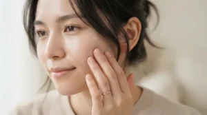 A close-up showing the smooth finish of a balancing mattifying primer for combination skin on bare cheeks.