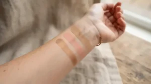 Different shades of long-lasting bronzer for oily skin swatched smoothly on a warm skin tone.