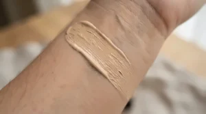 Smooth texture of a clear eye primer for oily eyelids swatched on the back of a hand.