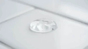 Close-up of a translucent silicone formula representing face primer vs pore-minimizing primer for oily skin.