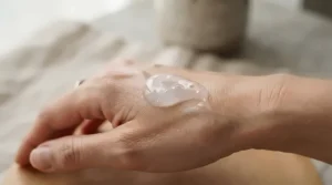 Swatching a rich hydrating face primer for dry skin on the back of a hand to show moisture